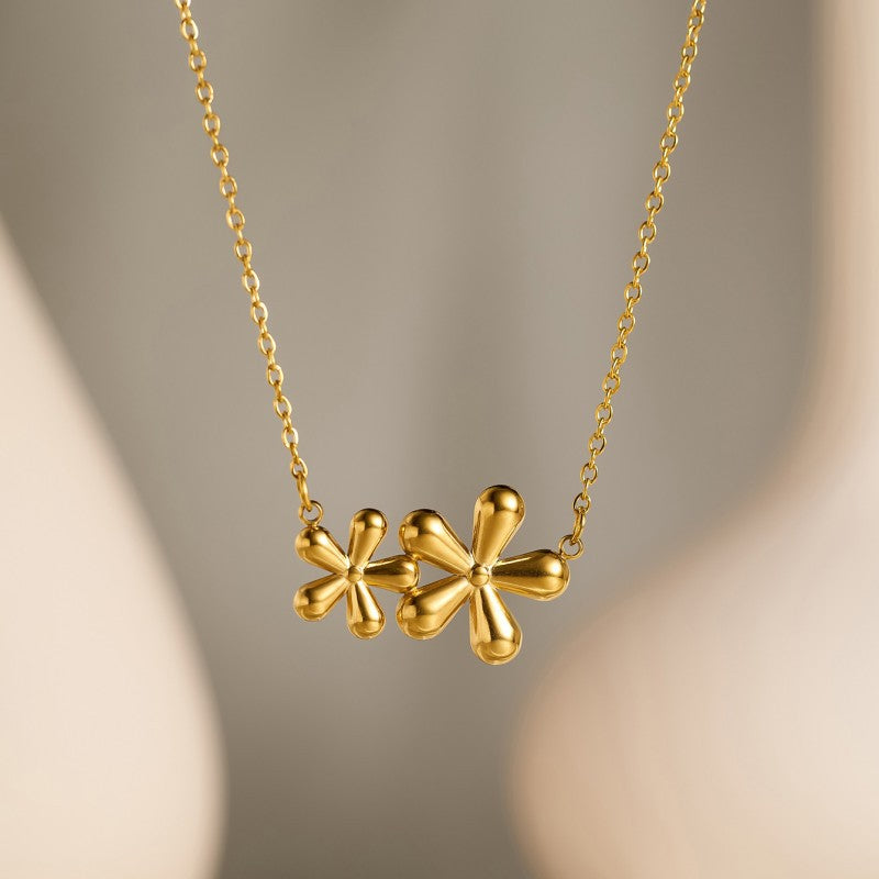 Halo Necklace, gold flower charm on a fine chain, close-up