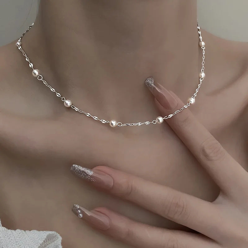 Perla Pearl Necklace, silver-tone pearl bead chain, close-up on the collarbone