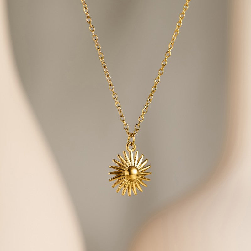Halo Necklace, gold sun charm on a fine chain, close-up